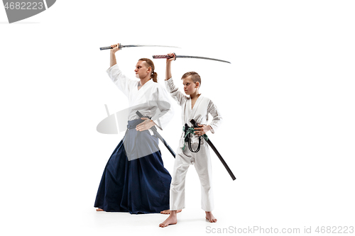 Image of Man and teen boy fighting at aikido training in martial arts school