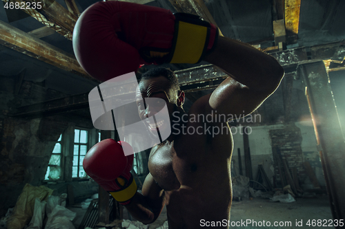 Image of Hand of boxer over black background. Strength, attack and motion concept