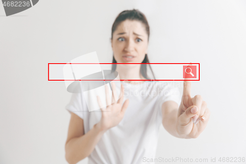 Image of Woman\'s hand with finger on gray background