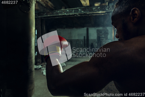 Image of Hand of boxer over black background. Strength, attack and motion concept