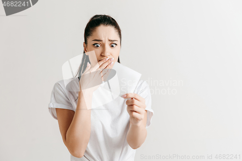 Image of Young woman with a sad expression lost a bet