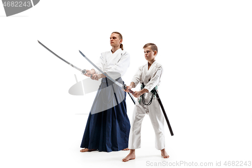 Image of Man and teen boy fighting at aikido training in martial arts school