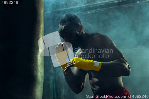 Image of Hand of boxer over black background. Strength, attack and motion concept