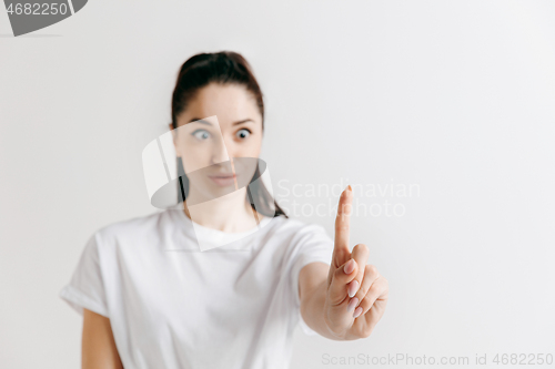 Image of Woman\'s hand with finger on gray background