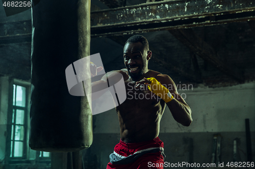 Image of Hand of boxer over black background. Strength, attack and motion concept