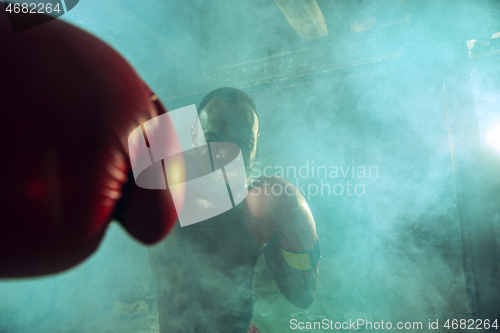 Image of Hand of boxer over black background. Strength, attack and motion concept