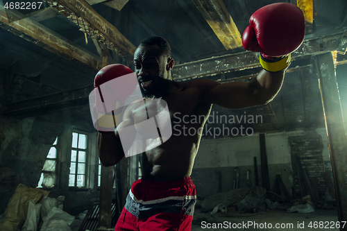 Image of Hand of boxer over black background. Strength, attack and motion concept