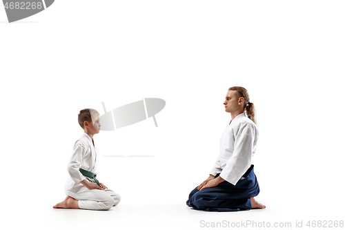 Image of Man and teen boy at aikido training in martial arts school