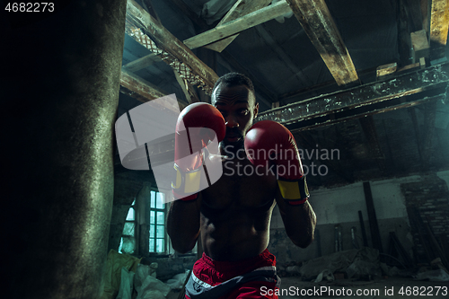 Image of Hand of boxer over black background. Strength, attack and motion concept