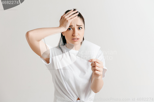 Image of Young woman with a sad expression lost a bet