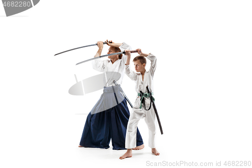 Image of Man and teen boy fighting at aikido training in martial arts school