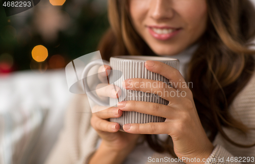 Image of close up of woman with cup of coffee on christmas