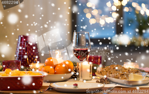 Image of glass of red wine and food on christmas table