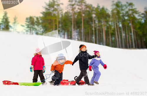 Image of happy little kids with sleds in winter