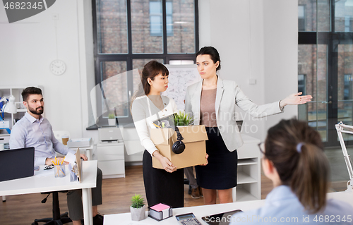 Image of executive seeing off fired female office worker