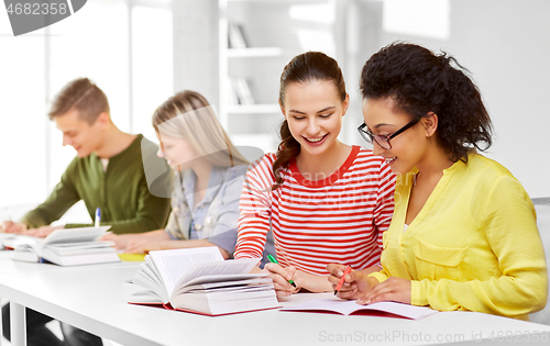 Image of high school students with books and notebooks