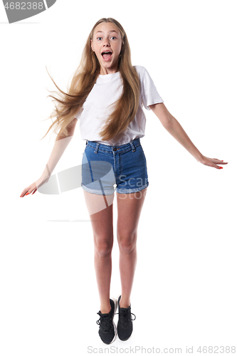 Image of Full length of happy joyful teen jumping