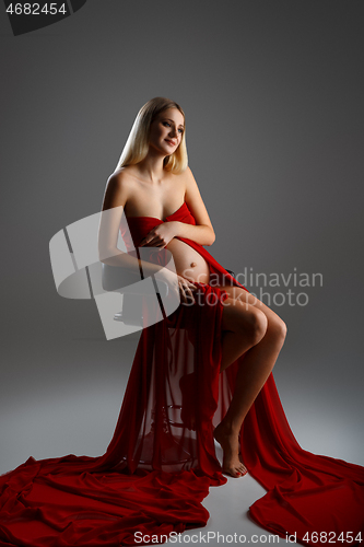 Image of Pregnant girl in red dress