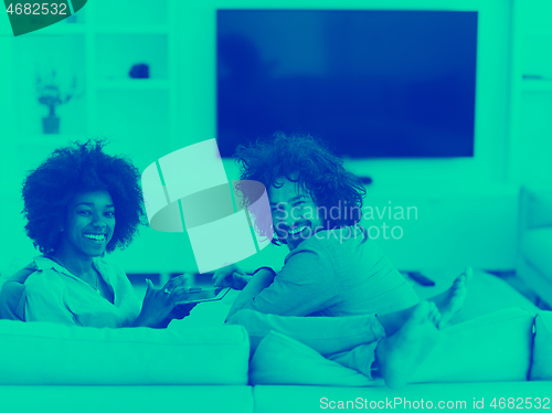Image of multiethnic couple in living room