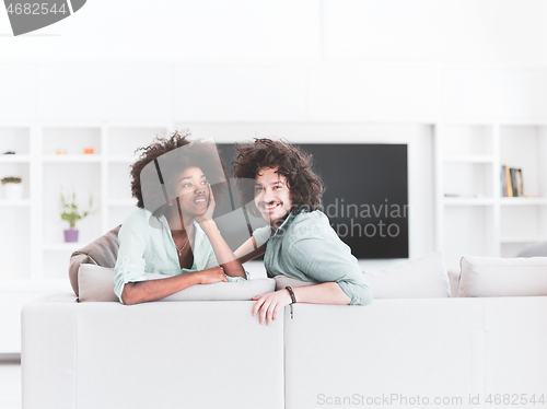 Image of young multiethnic couple in living room