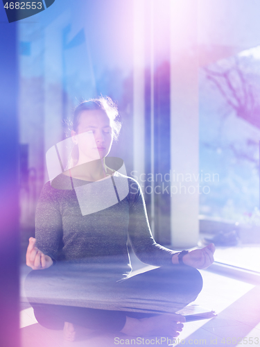 Image of young woman doing morning yoga exercises