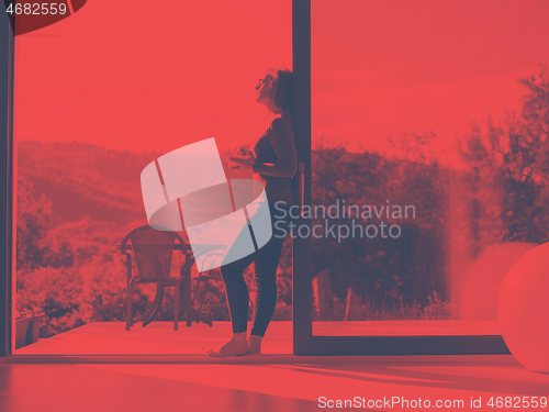 Image of woman eating breakfast in front of her luxury home villa