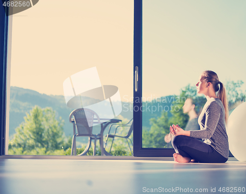 Image of young woman doing morning yoga exercises