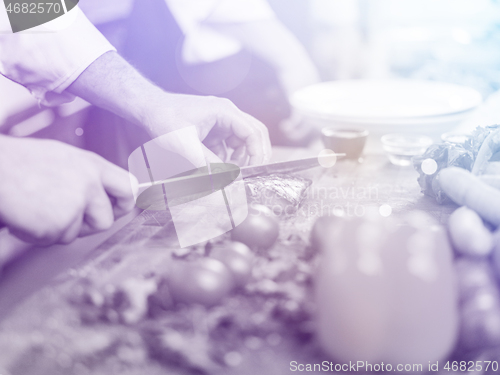 Image of Chef hands preparing marinated Salmon fish