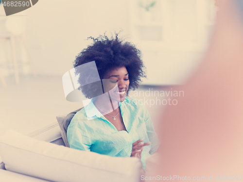 Image of african american woman at home using digital tablet