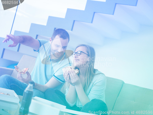 Image of couple eating pizza in their luxury home villa