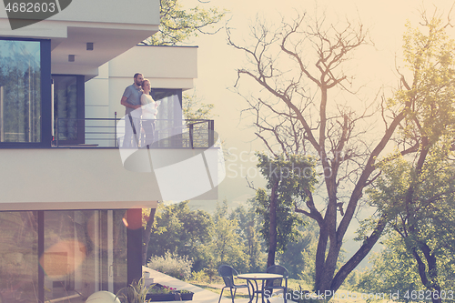 Image of couple enjoying morning coffee on balcony