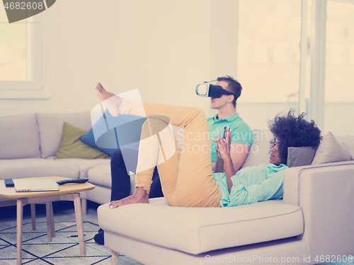 Image of Multiethnic Couple using virtual reality headset