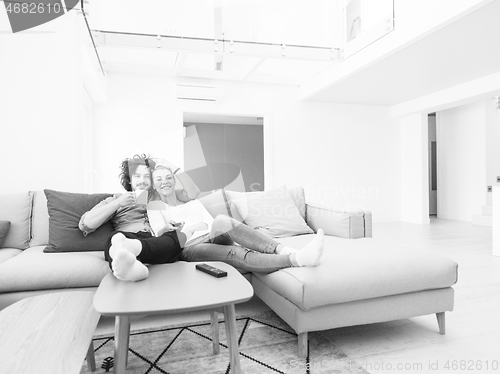 Image of Young couple on the sofa watching television