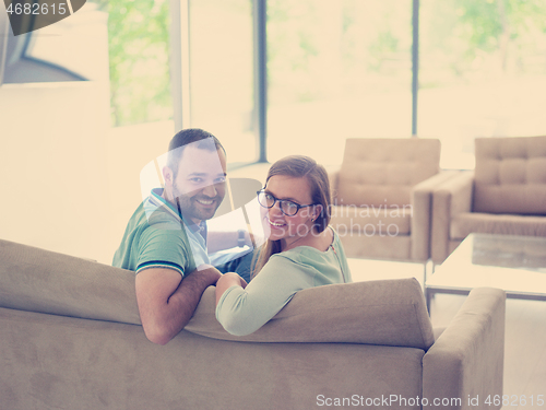 Image of Rear view of couple watching television