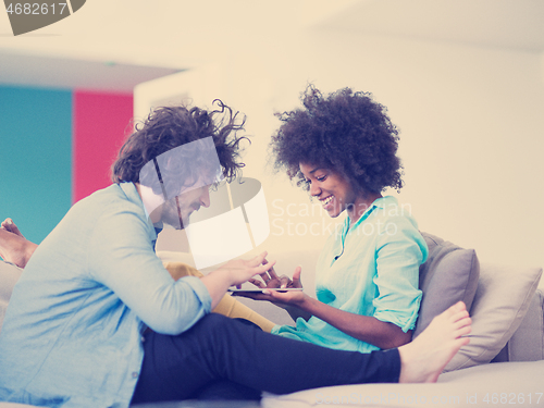 Image of multiethnic couple in living room