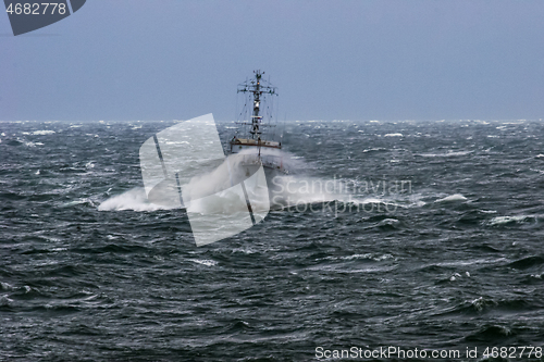 Image of NATO military ship at sea during a storm.