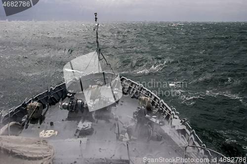 Image of NATO military ship at sea during a storm.