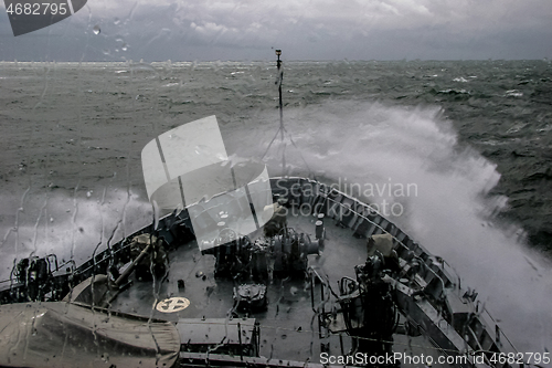 Image of NATO military ship at sea during a storm.