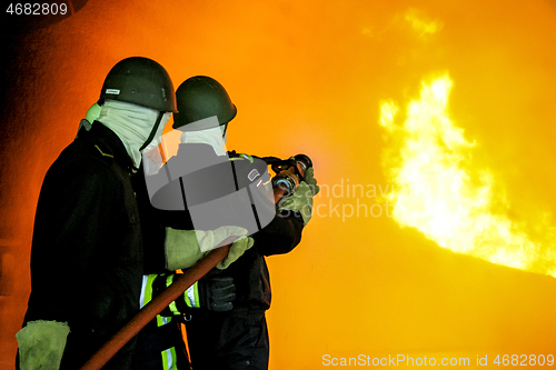 Image of Firefighters training for fire fighting.