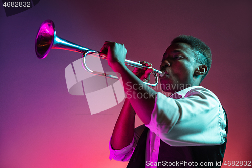 Image of African American jazz musician playing trumpet.