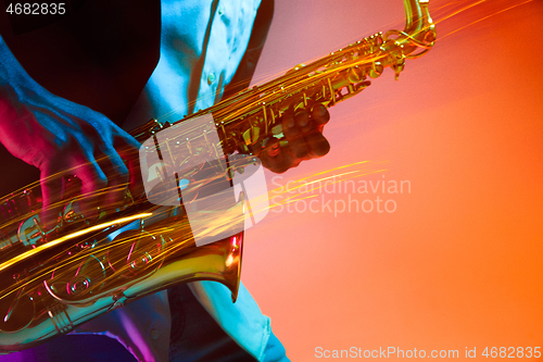 Image of African American jazz musician playing the saxophone.