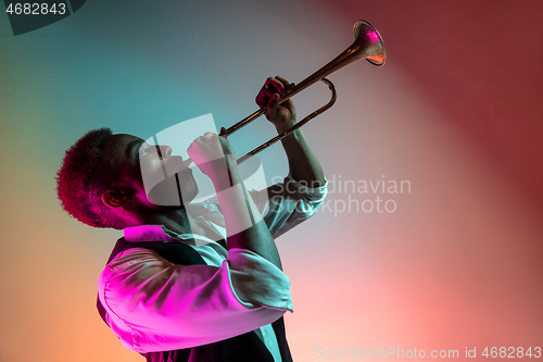 Image of African American jazz musician playing trumpet.