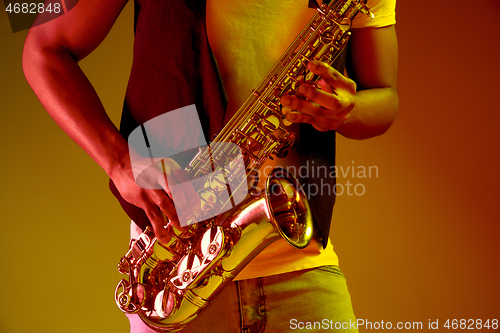 Image of African American jazz musician playing the saxophone.