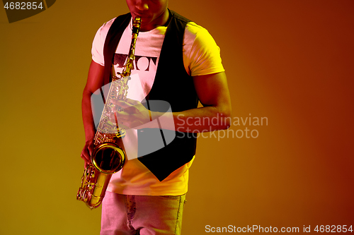 Image of African American jazz musician playing the saxophone.