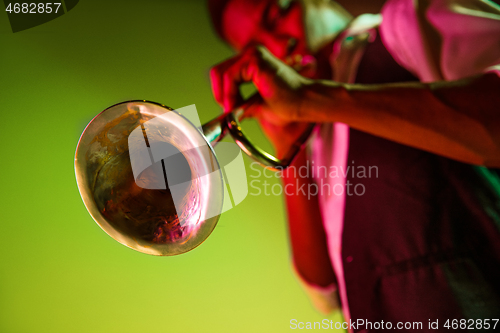 Image of African American jazz musician playing trumpet.