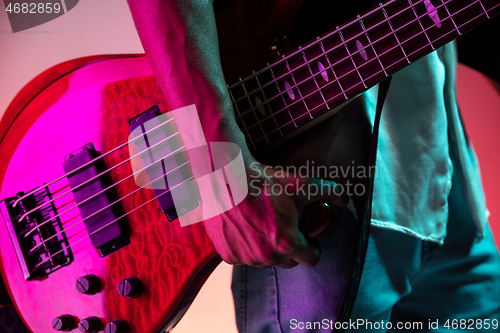 Image of African American jazz musician holding bass guitar.