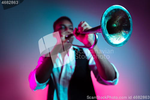 Image of African American jazz musician playing trumpet.