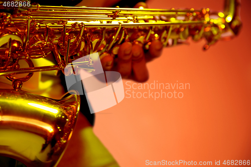 Image of African American jazz musician playing the saxophone.