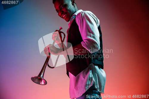 Image of African American jazz musician playing trumpet.