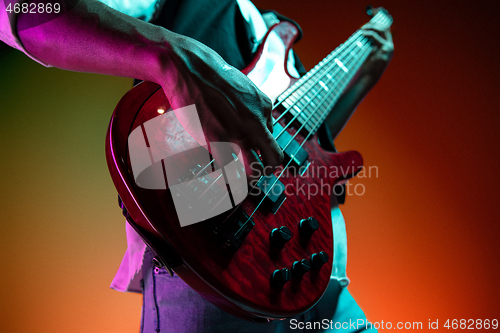 Image of African American jazz musician playing bass guitar.